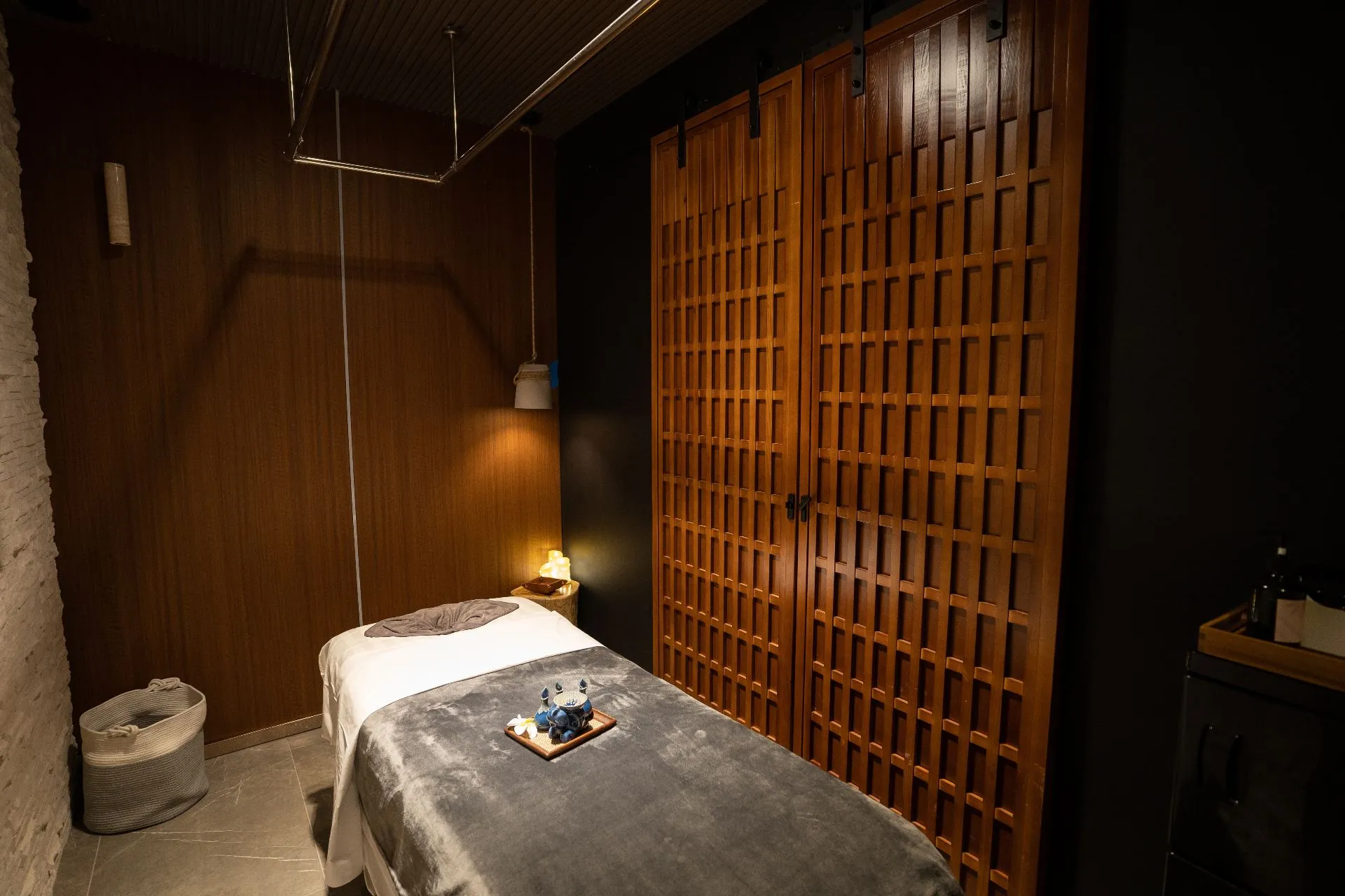 Warm, private treatment room at Zenko Spa with wood tones and soft lighting